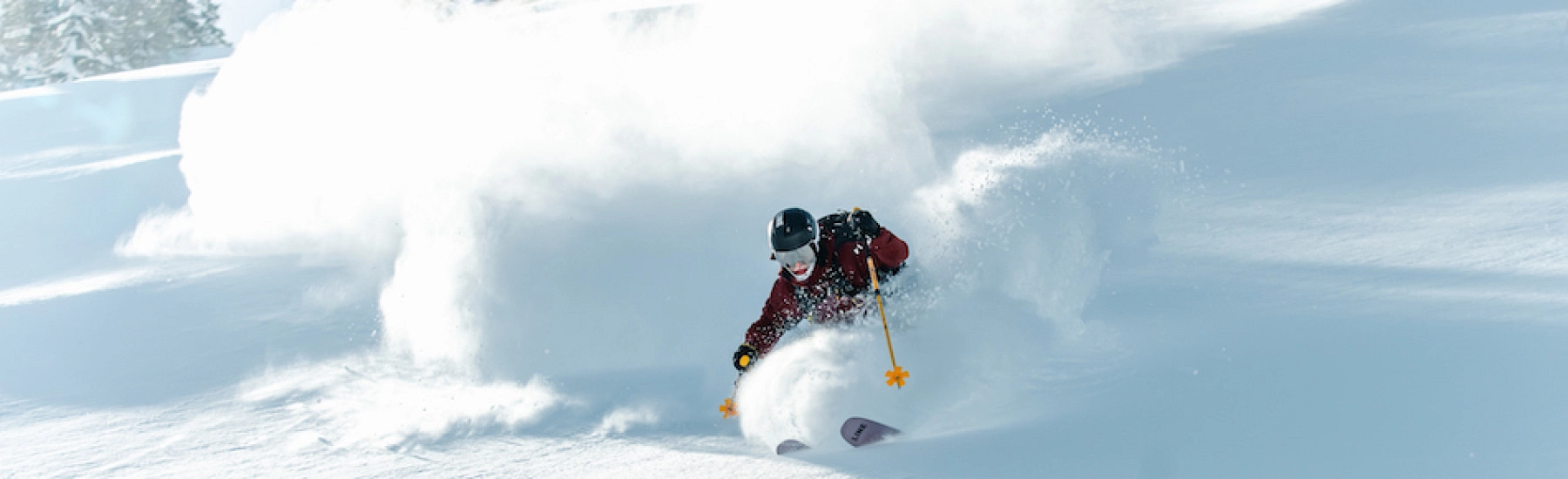 Skifahrer im freien Gelände mit Schnee und Wolken